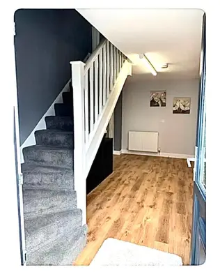 an empty room with a staircase in a house at The Little House, Oswestry in Oswestry