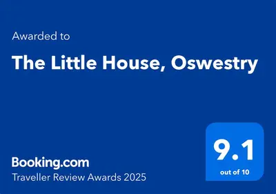 a blue sign that reads the little house and university at The Little House, Oswestry in Oswestry