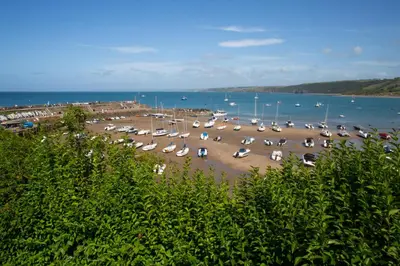 a bunch of cars parked in a parking lot next to the water at 3 Prospect Place New Quay in New Quay