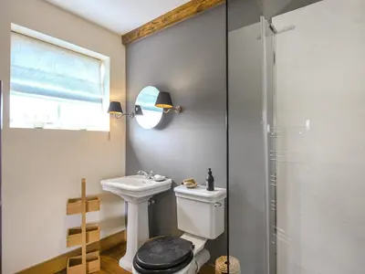 a bathroom with a toilet and a glass shower at The Haven in Ludlow