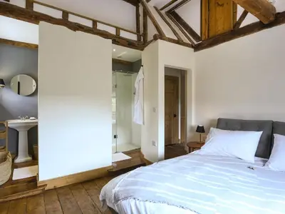 a bedroom with a large bed and a bathroom at The Haven in Ludlow