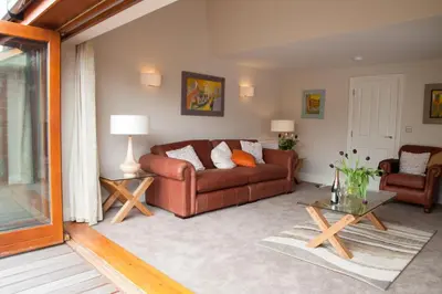 a living room with a couch and a table at Hay Retreats in Hay-on-Wye