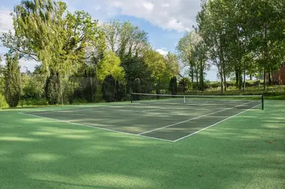 a tennis court with two tennis nets on it at The Hop Kiln in Leominster