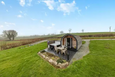 a small cabin in the middle of a grassy field at 1 Bed in Llanfyllin oc-p29023 in Llanfyllin