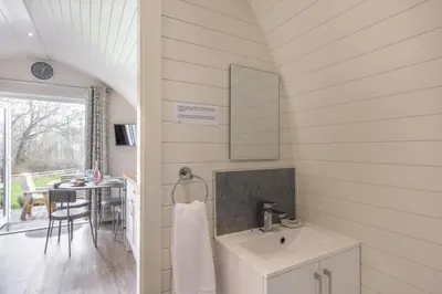 a white bathroom with a sink and a table at 1 Bed in Llanfyllin oc-p29023 in Llanfyllin