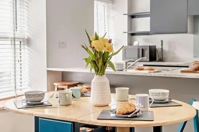 a kitchen with a table with a vase of flowers at 2 Bed in Aberaeron oc-t29116 in Aberaeron