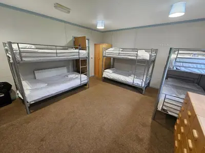 a room with three bunk beds in it at Rural Group Lodging 19 rooms 83 beds Games room in Elerch