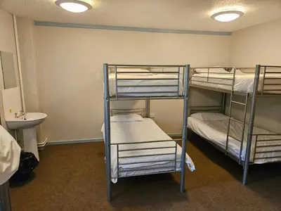 two bunk beds in a room with a sink at Rural Group Lodging 19 rooms 83 beds Games room in Elerch
