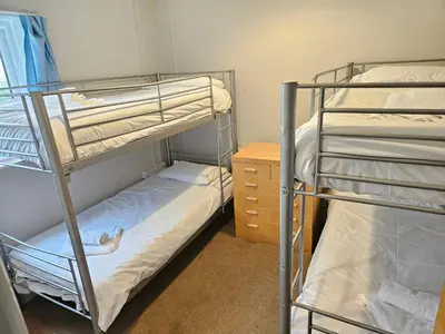 a bunk bed room with two bunk beds and a dresser at Rural Group Lodging 19 rooms 83 beds Games room in Elerch