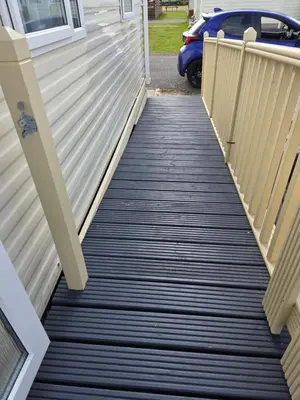 a walkway leading down to a house at Bayview at Pengarreg in Llanrhystyd