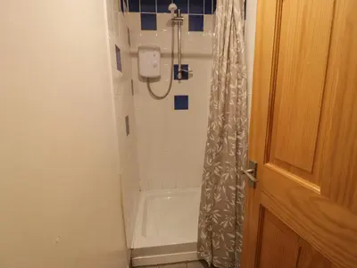 a bathroom with a shower and a bath tub at Graig Las The Stables in Oswestry