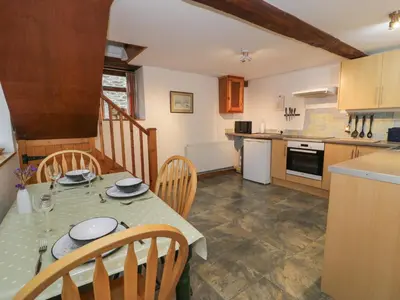 a kitchen and dining room with a table and chairs at Graig Las The Stables in Oswestry