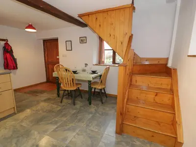 a kitchen and dining room with a table and chairs at Graig Las The Stables in Oswestry