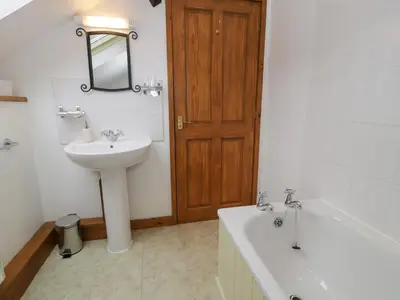 a bathroom with a sink and a toilet and a tub at Graig Las The Barn in Oswestry