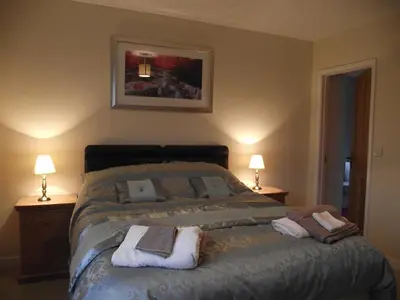 a bedroom with a bed with towels on it at Cob Cottage in Tregaron