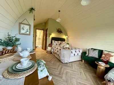 a bedroom with a bed and a couch at Willow in Llanidloes