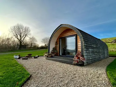 a dome house with a large window in a field at Willow in Llanidloes