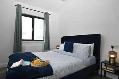 a bedroom with a bed with a tray of food on it at Cae Pren in Newtown