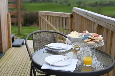 a table with a bowl of food and a plate of food at Cae Bedw in Newtown
