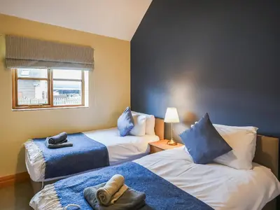 a hotel room with two beds and a window at Uk46555 - Ragleth in Church Stretton