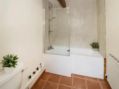 a bathroom with a white tub and a shower at Uk46555 - Ragleth in Church Stretton