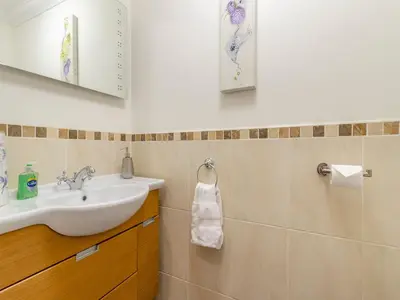 a bathroom with a sink and a mirror at Derwen Haidd in Llanafan