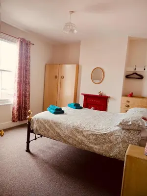 a bedroom with a bed with blue towels on it at Llangollen Townhouse 4 bedroom in Llangollen
