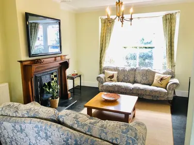 a living room with two couches and a fireplace at Llangollen Townhouse 4 bedroom in Llangollen