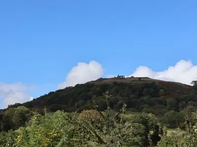 a hill with clouds on top of it at Llangollen in Llangollen
