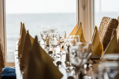 a table with wine glasses on top of it at Marine Apartment in Aberystwyth