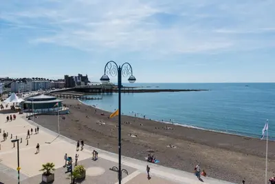 a group of people on a beach near the ocean at Marine Apartment in Aberystwyth