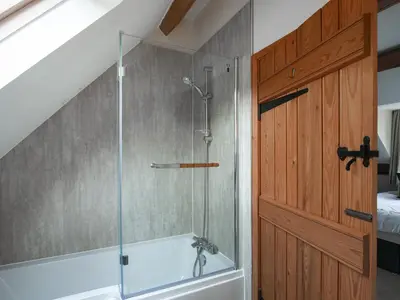 a bathroom with a shower with a glass door at Uk46589 - Kibble in Church Stretton