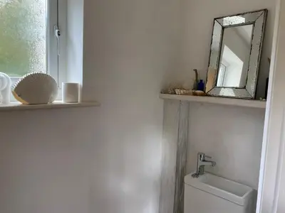 a bathroom with a mirror and a toilet at Tamarisk in Clyro