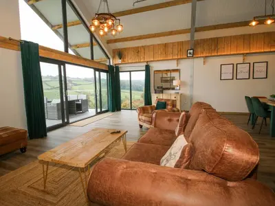 a living room with a couch and a table at Bwncath in Welshpool
