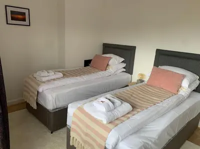 a room with three beds with towels on them at Mountain views in the heart of Brecon Town in Brecon