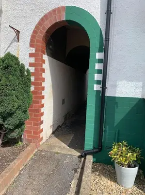 a brick and green arched entrance to a building at Mountain views in the heart of Brecon Town in Brecon
