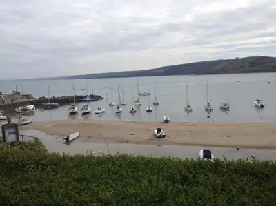 a bunch of boats are docked in the water at Quirky Cottage with Private Garden Nr New Quay Cardigan Bay in Llandysul