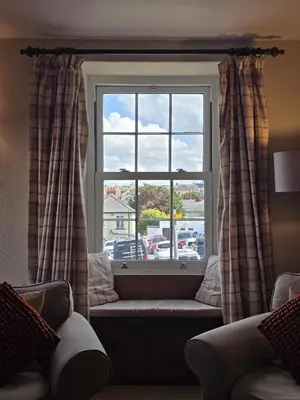 a window with a bench in front of a window at 3 Prospect Place, New Quay, sleeps 6, parking, sea views, dog friendly in New Quay