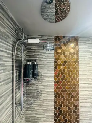 a shower in a bathroom with a glass shower at Tiny Romantic Retreat with Hot Tub on a Country Estate near Cardigan Bay in Eryri Snowdonia in Llanbedr