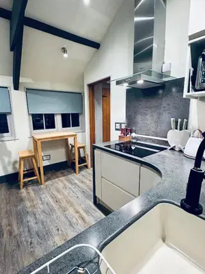 a kitchen with a sink and a counter top at Tiny Romantic Retreat with Hot Tub on a Country Estate near Cardigan Bay in Eryri Snowdonia in Llanbedr