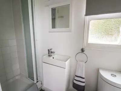 a bathroom with a sink and a toilet and a window at Chalet 32 in Aberystwyth
