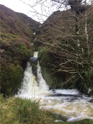 a waterfall in the middle of a river at Stunning views of Ynyshir & Southern Snowdonia in Machynlleth