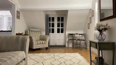 a living room with a couch and chairs and a table at Apartment Sleeps 2 with Wi-Fi in Ludlow