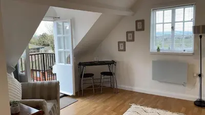 a living room with a table and a window at Apartment Sleeps 2 with Wi-Fi in Ludlow