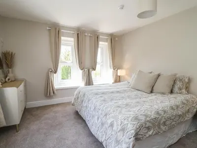 a bedroom with a bed and a window at Serenity House, The Retreat in Llangammarch Wells