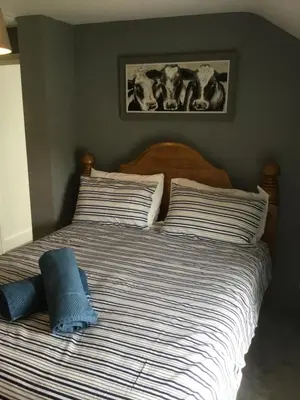 a bedroom with a bed with two pillows at Harbour House in Barmouth