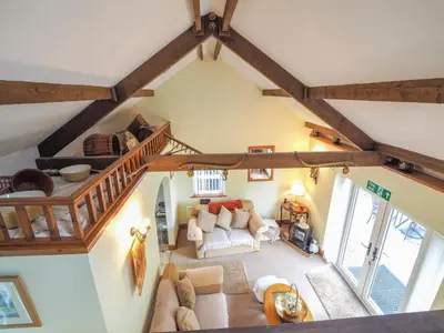 an overhead view of a living room with wooden ceilings at Nyth y Wennol Aberaeron in Llanarth