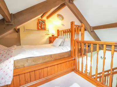 a bedroom with a bed in the attic at Nyth y Wennol Aberaeron in Llanarth