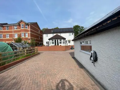 a brick courtyard with a phone on the side of a building at Twyford Homestay B&B in Llandrindod Wells