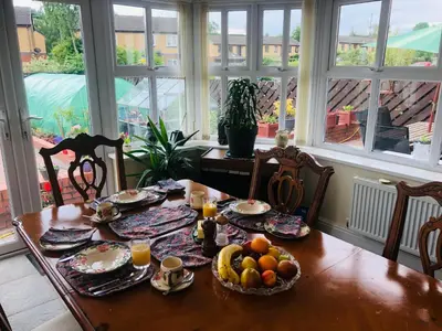 a dining room table with food and fruit on it at Twyford Homestay B&B in Llandrindod Wells